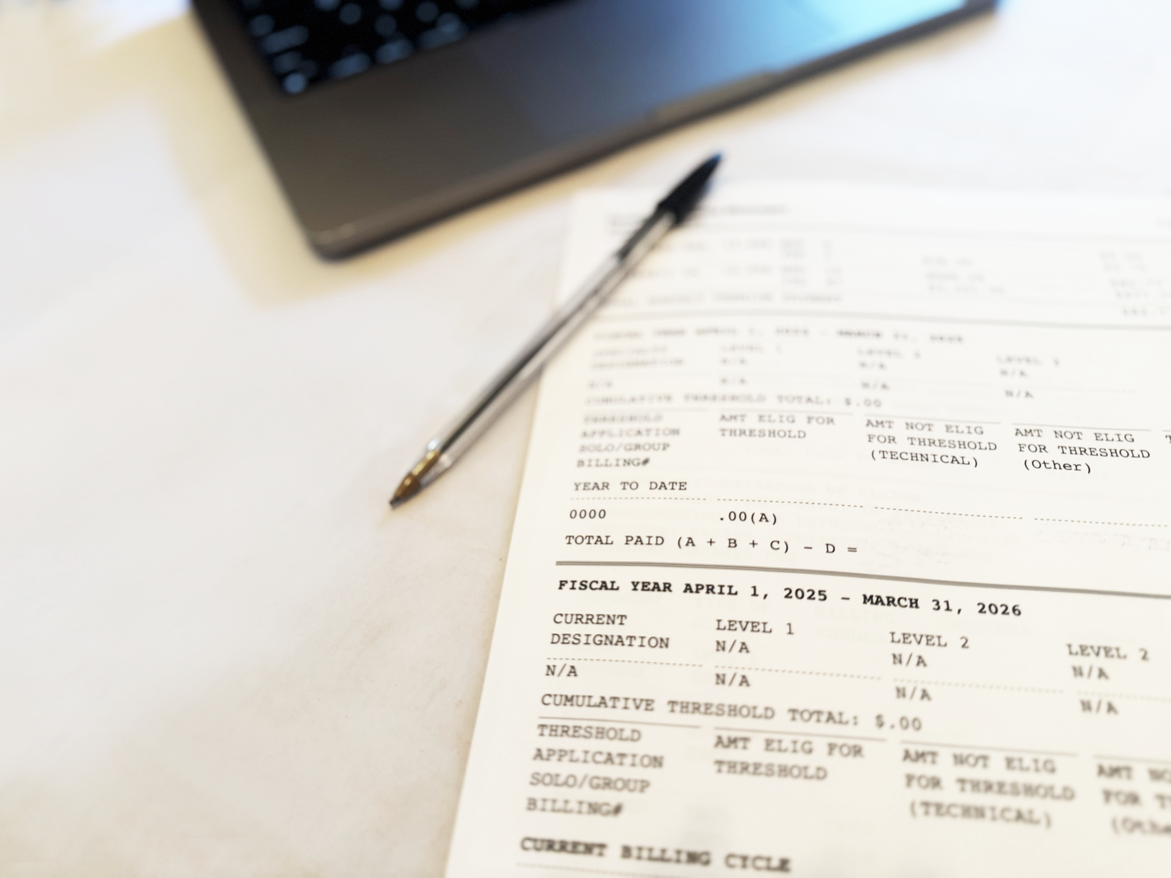 A doctor's remittance advice form and a pen are seen here. 